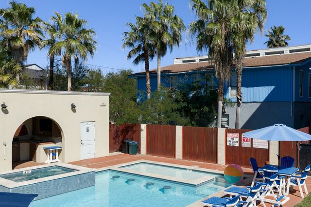 Pool with arches and palms at Athena Ares Seaside Estate, South Padre Island