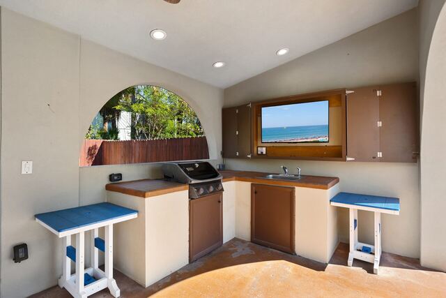 Outdoor poolside seating at Athena Ares Seaside Estate, South Padre Island