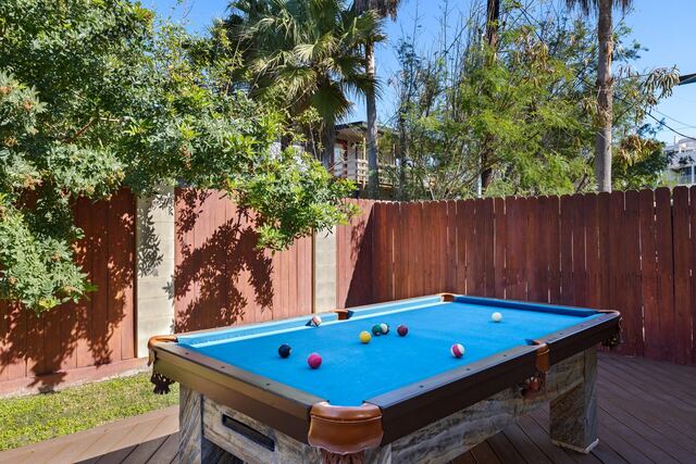 Pool with arches and palms at Athena Ares Seaside Estate, South Padre Island
