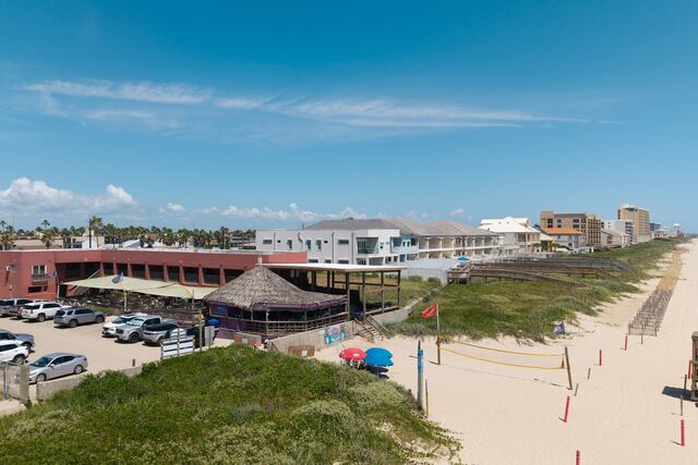 Outdoor poolside seating at Athena Ares Seaside Estate, South Padre Island