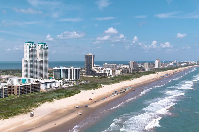 Pool deck loungers and umbrella at Athena Ares Seaside Estate, South Padre Island